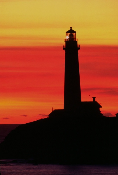 Sunset red sky behind Pigeon Pt lighthouse 12-85